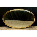 A early 20th century oval wall mirror, roundel and flower head cast motifs, bevelled plate, 52cm x