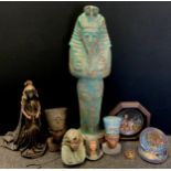 An Egyptian revival carved wooden figure, others Busts of Nefertiti etc, doll, plates, Wall mask etc