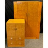 An Art Deco quilted maple double wardrobe, 183cm high x 122cm wide x 50cm deep, and a conforming