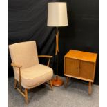 An Ercol ‘Easy’ armchair, model number 334, oatmeal upholstery; a 1970’s teak and brass standard