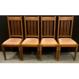 A set of four Arts and Crafts style dining chairs