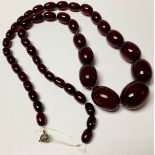 A strand of graduated cherry amber beads, 35cm drop, 71g