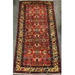 A North west Persian Malayer rug / carpet, hand-knotted with a central field of stylised flowers,