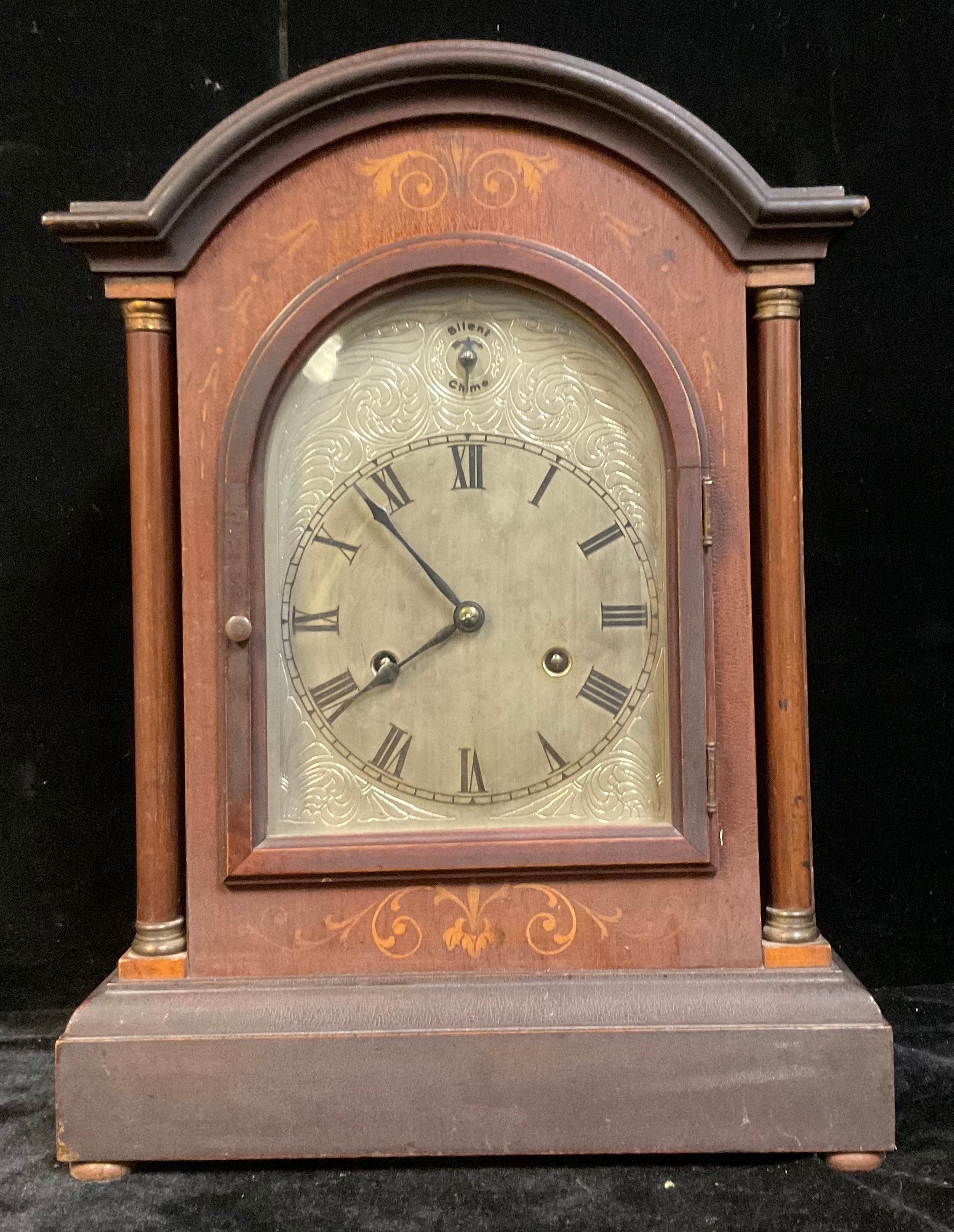 A bracket type mantel clock, arched silvered dial, Roman numerals, twin winding holes, 42.5cm