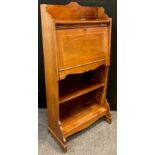 An Edwardian mahogany student’s bureau, three-quarter galleried top, above a fall door enclosing