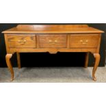 A reproduction Georgian style oak dresser base / sideboard, over-sailing top, three deep drawers