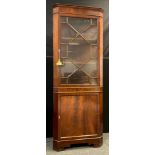 A Georgian style reproduction mahogany corner cabinet, 183cm high x 70cm wide.