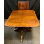 A Reproduction mahogany twin pedestal extending dining table, rounded rectangular top with box