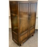 A mid 20th century Oak double wardrobe, 182cm high x 117cm wide x 48.5cm.