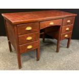 A stained pine knee-hole desk, single drawer to frieze, three short drawers to each pedestal,