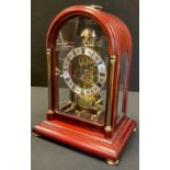 A Hermle mahogany cased skeleton clock, domed case, silvered dial, Roman numerals, mechanical