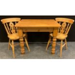 A country kitchen style pine dining table / breakfast table, and a pair of conforming Beechwood