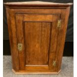 An early George III oak corner cupboard, c.1770, (reputedly from the Ogston Estate).