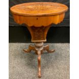 A Victorian walnut oval work table, the quarter veneered top inlaid with stylised foliage, the