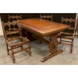 An Ercol dark Elm extending trestle dining table, and set of four conforming Elm chairs, ‘Old