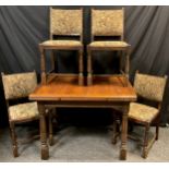 An oak draw-leaf dining table and four chairs