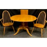 An Ercol light elm extending dining table, pedestal base, 73cm high x 98cm x 111cm oval (extending