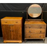 A mid 20th century oak dressing table, bevelled circular mirror, three long graduated drawers,