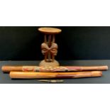 A Digerido, painted with a salamander; another; lizard; a carved African stool (4)