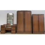 An Art Deco oak bedroom suite - comprising double wardrobe, small wardrobe, and dressing table.