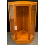 A Nathan teak corner cabinet, two tiers of glass shelving, 124cm high x 79.5cm wide x 60cm.