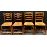 Two matched pairs of 19th century oak and elm ladder back kitchen chairs, woven rush seats, turned