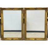 A pair of large gilt framed wall mirrors, 19th century style ornate gilt frames, bevelled glass,