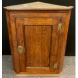 An early George III oak corner cupboard, c.1770, (reputedly from the Ogston Estate).