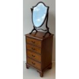 A George III style reproduction walnut small chest of drawers / bedside cabinet, over-sailing