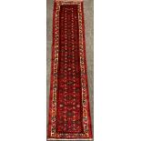 A North west Persian Malayer runner carpet, hand-knotted in red, deep blue, turquoise, and green,