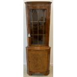 A Burr Walnut floor standing corner cabinet, by Cameo furniture, glazed top door enclosing two tiers