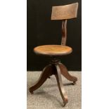 A Late Victorian/Edwardian Kendrick and Jefferson oak desk chair, revolving seat, cast iron body