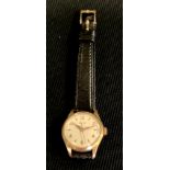 A lady's Longines gold coloured metal wristwatch, black leather strap