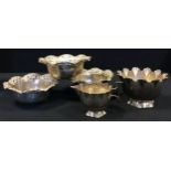 A set of three Chinese 800 silver bowls, planished body with floral undulating rim, stamped HR