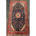A central Persian Sarouk carpet, hand-knotted with a central lotus form medallion, within a stylised