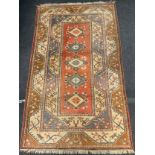 A Middle Eastern wool rug / carpet, knotted in subtle tones of blue, ochre, pink and white, 260cm