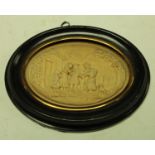 A 19th century wax picture, in relief with a genre scene, oval, 7cm x 9.5cm