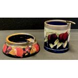 A Moorcroft pottery Pomegranate pattern ashtray, silver plated collar, 11.3cm diameter, impressed