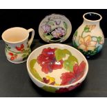 A Moorcroft Pottery Water Cranesbill pattern vase, 14cm high; Rosehip pattern cup, Hibiscus bowl,