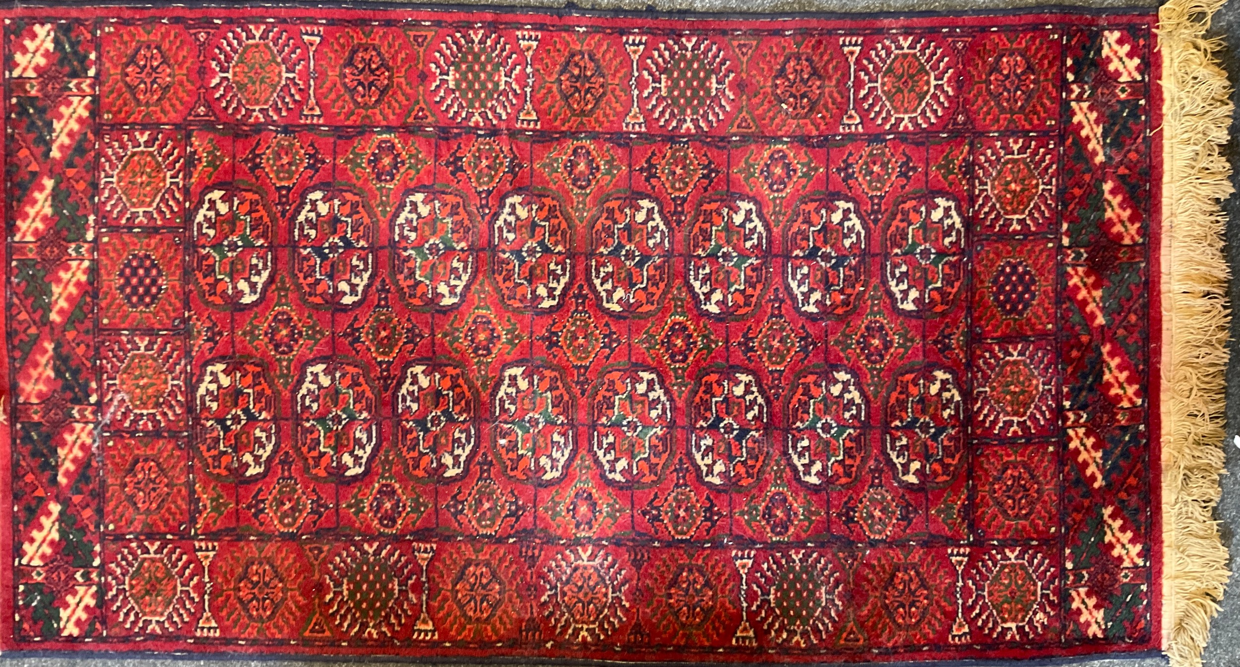 A middle-eastern woollen rug, 154cm x 85cm.