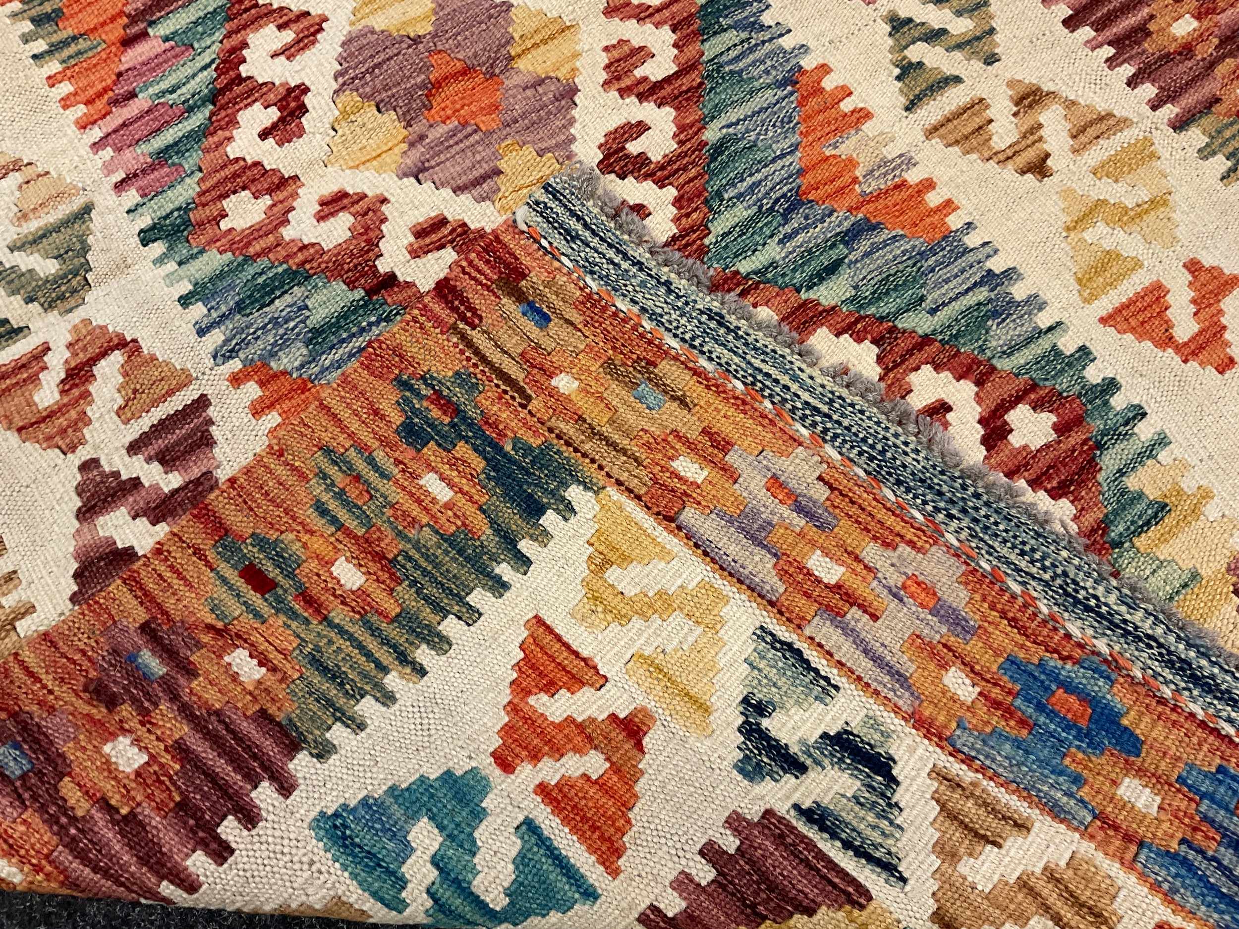 A Turkish Anatolian Kilim rug / carpet, knotted in bright tones of red, orange, green, and cream, - Image 2 of 2