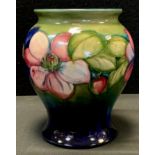 A Moorcroft Pottery Clematis pattern vase, blue ground, impressed and painted marks, 16.5cm high.