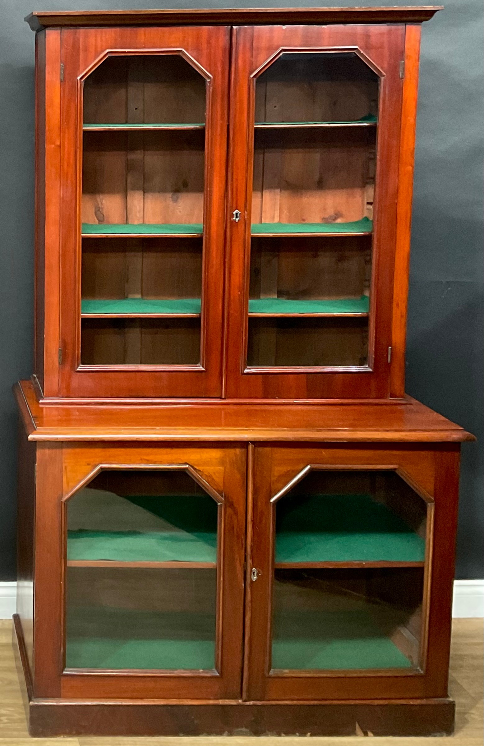 A late 19th/early 20th century mahogany library bookcase, moulded cornice above a pair of glazed