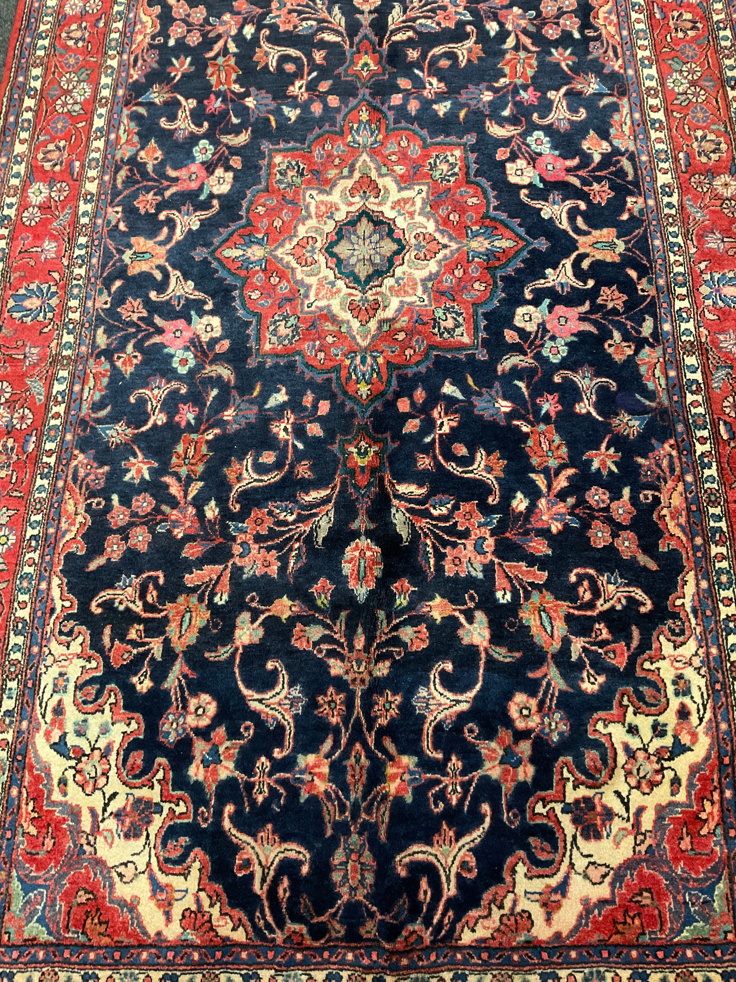 A central Persian Sarouk carpet, hand-knotted with a central lotus form medallion, within a stylised - Image 2 of 3