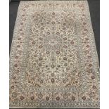 A Central Persian Kashan carpet / rug, knotted in pale cream, blue and red, the intricate central