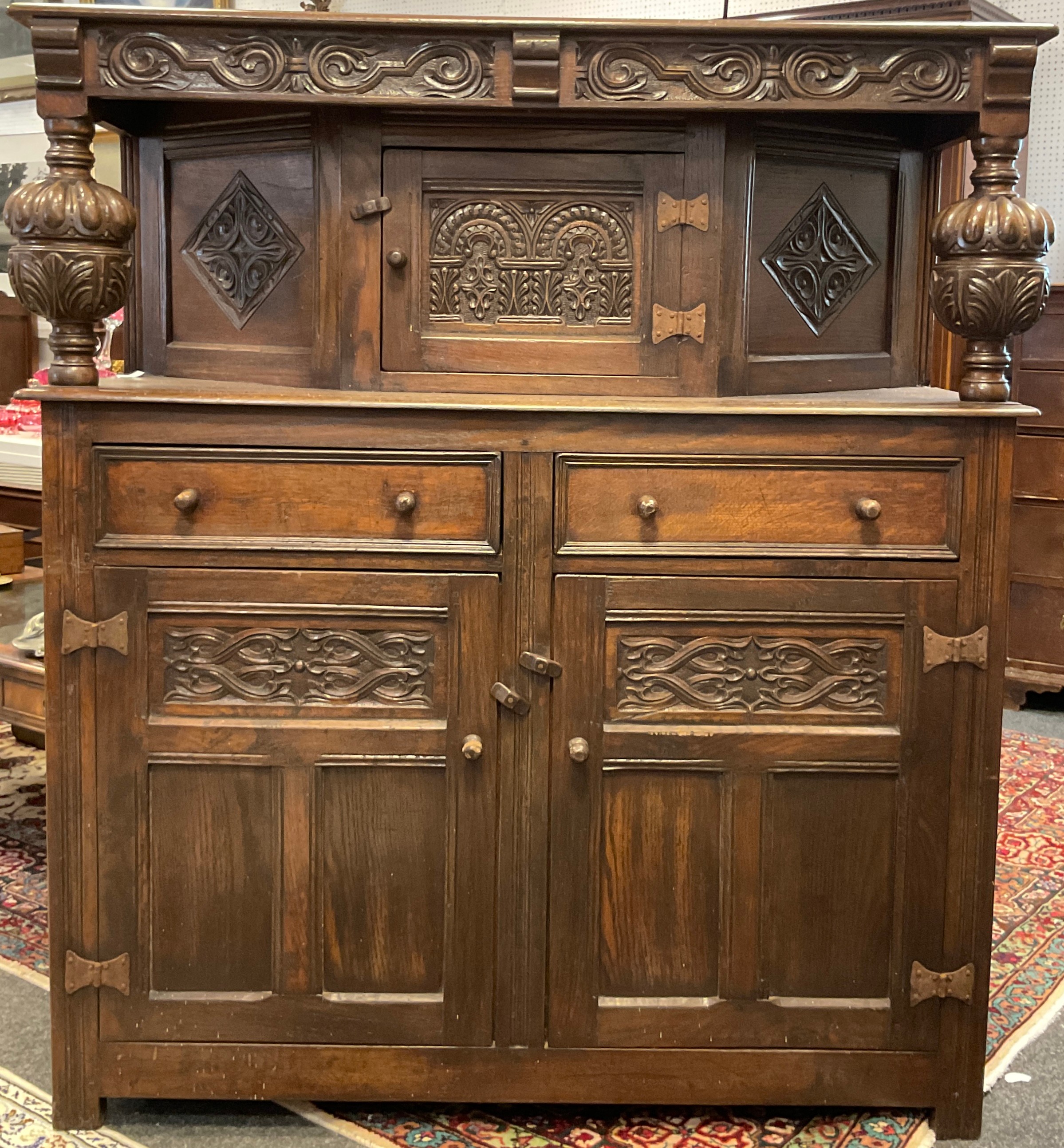 A carved oak court cupboard, 138cm high x 127cm wide x 44cm.