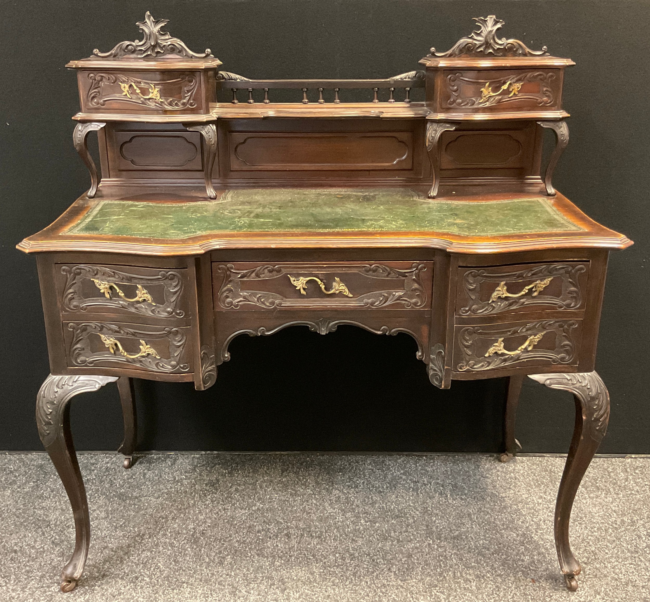 An early 20th century reproduction Louis XIV / Rococo style mahogany writing desk, carved