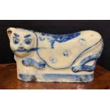 A Chinese pillow, as a reclining cat, painted in tones of underglaze blue, 26cm wide, 19th century