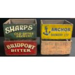A set of four painted wooden advertising bottle crates