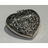 A silver heart shaped vesta case